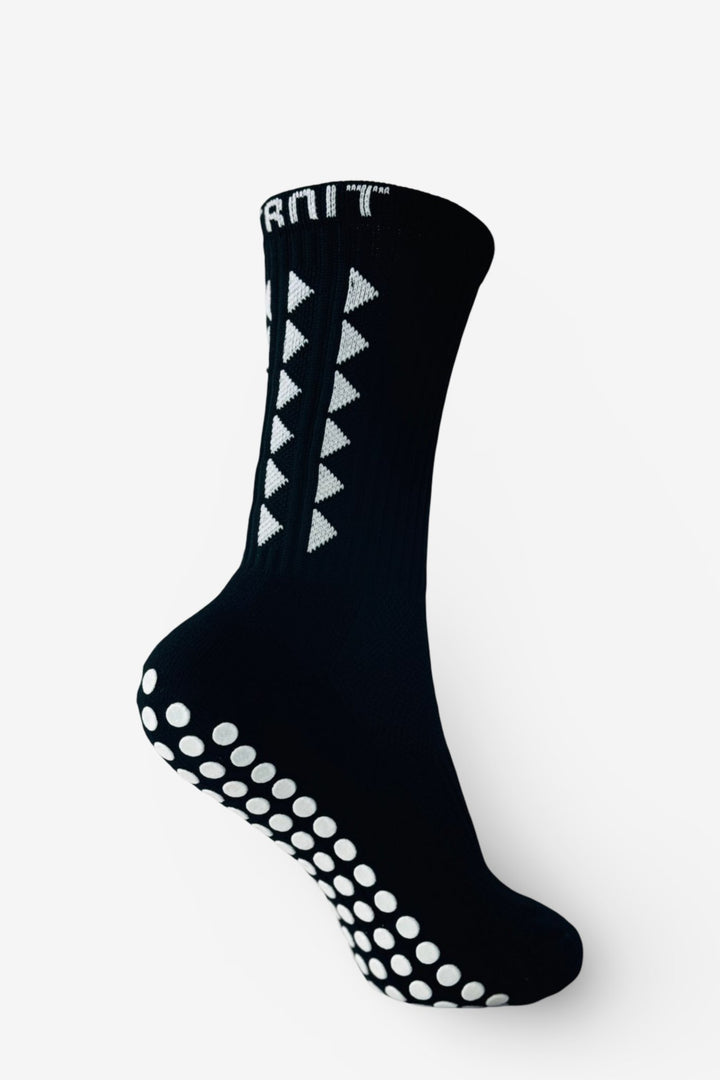 FitKnitSocks black grip socks featuring a white geometric pattern and anti-slip soles, designed for enhanced stability and performance.